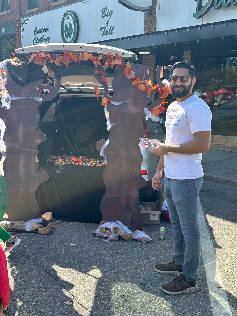 Mustafa Sandhu at his decorated trunk with candy ready for trick-or-treaters